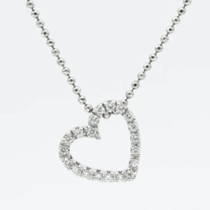 A diamond heart necklace is shown on a chain.